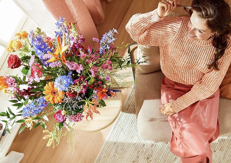 Happy recipient with flowers in Oudezijl